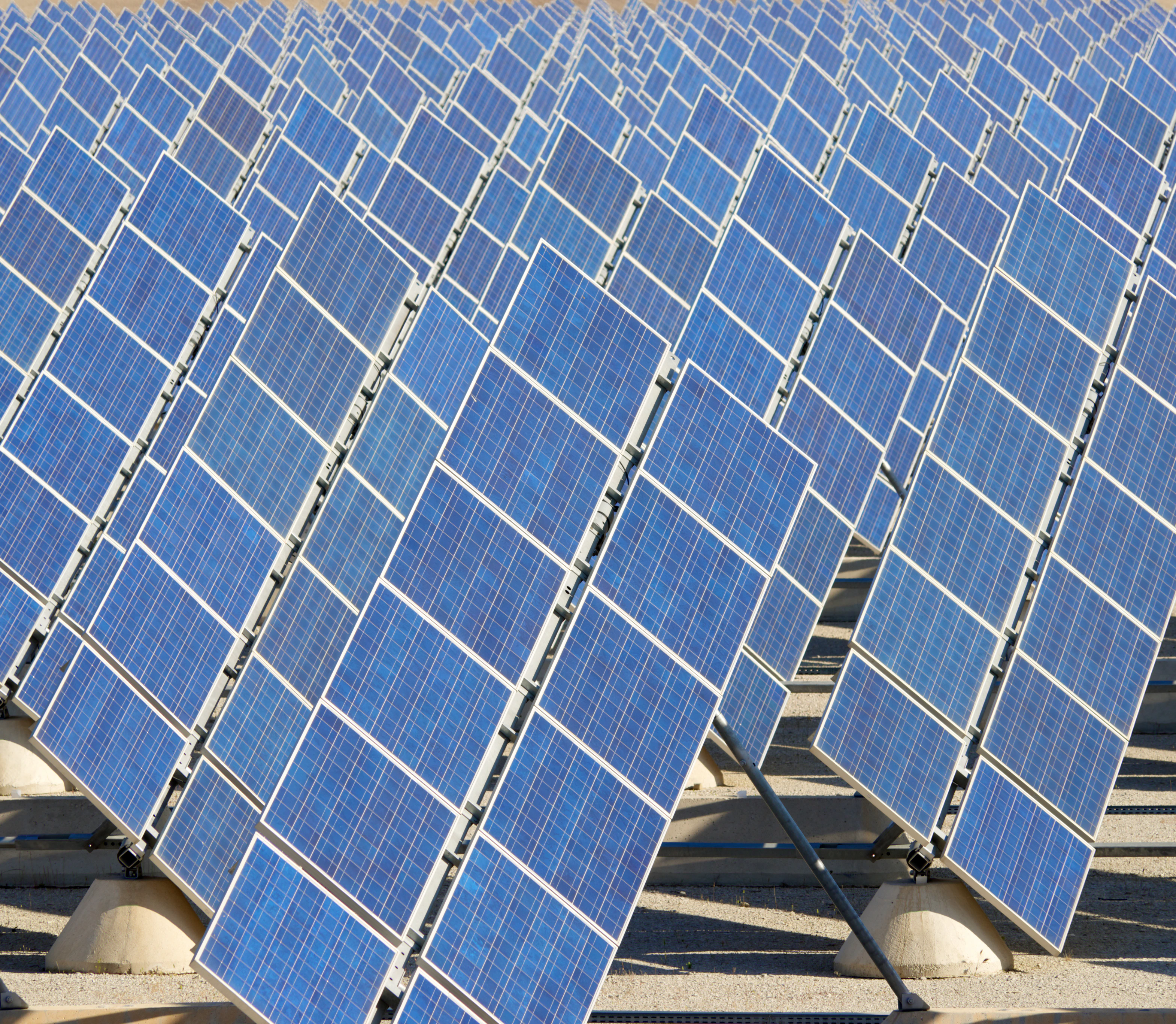 Rows of solar panels under a blue sky